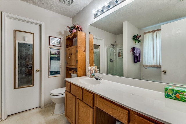 bathroom with vanity, a textured ceiling, toilet, and walk in shower