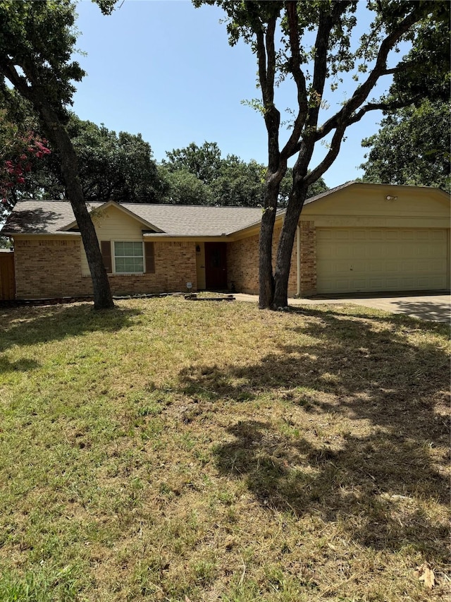 ranch-style home with a garage and a front yard