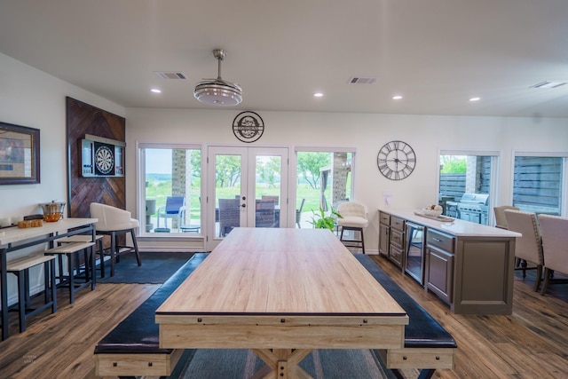 dining area with wine cooler, dark hardwood / wood-style flooring, and french doors