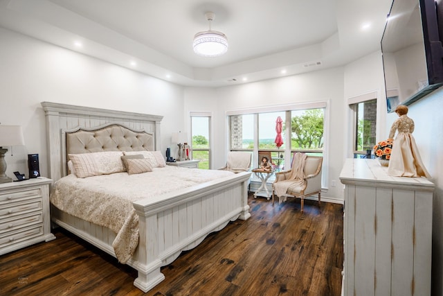 bedroom with dark wood-type flooring and a towering ceiling