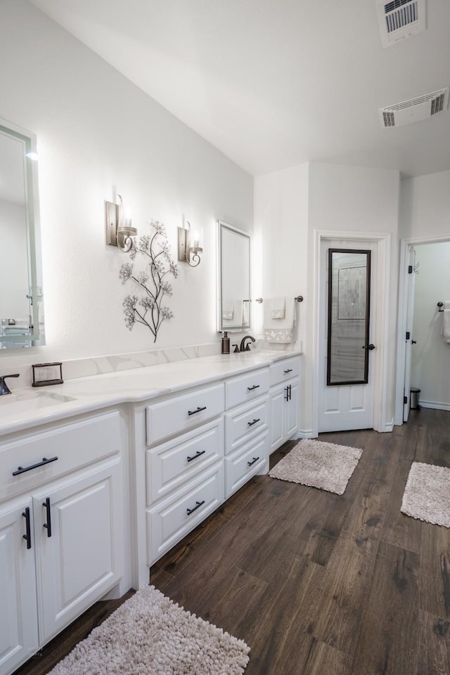 bathroom with vanity and hardwood / wood-style floors