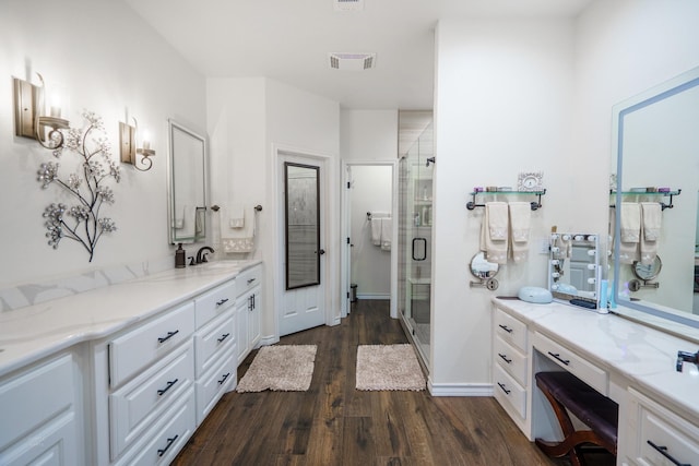 bathroom with vanity, an enclosed shower, and wood-type flooring