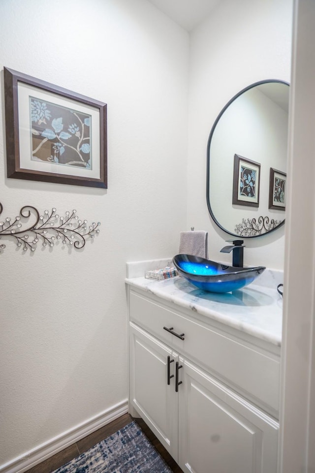 bathroom featuring hardwood / wood-style flooring and vanity