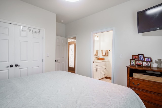 bedroom with ensuite bathroom and a closet