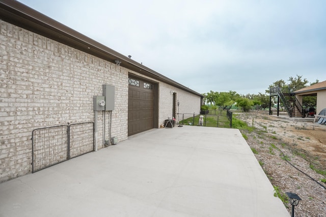 view of patio featuring a garage