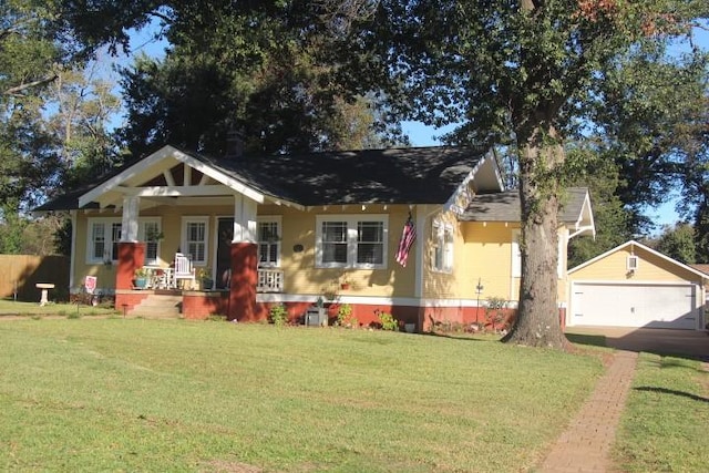 view of front of house with a garage, an outdoor structure, covered porch, and a front yard