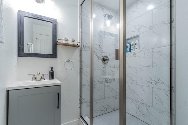 bathroom with vanity and a shower with door