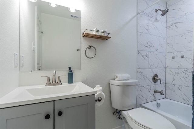 full bathroom with vanity, toilet, and tiled shower / bath