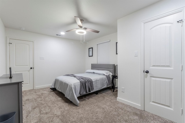 bedroom featuring light colored carpet and ceiling fan