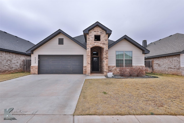 view of front of home with a garage and a front lawn