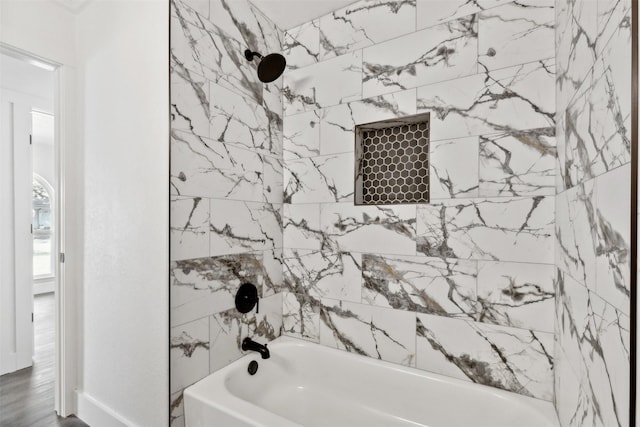 bathroom with tiled shower / bath combo and hardwood / wood-style flooring