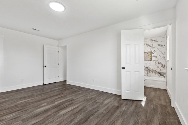 unfurnished bedroom featuring dark wood-type flooring