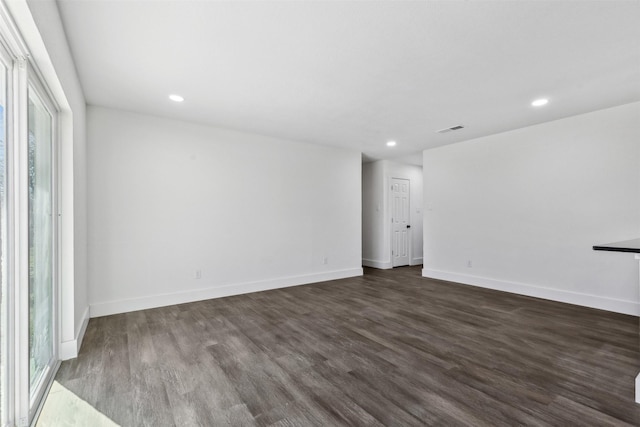 unfurnished room with dark hardwood / wood-style floors