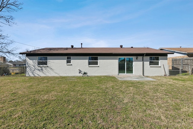 back of house with a yard and a patio area