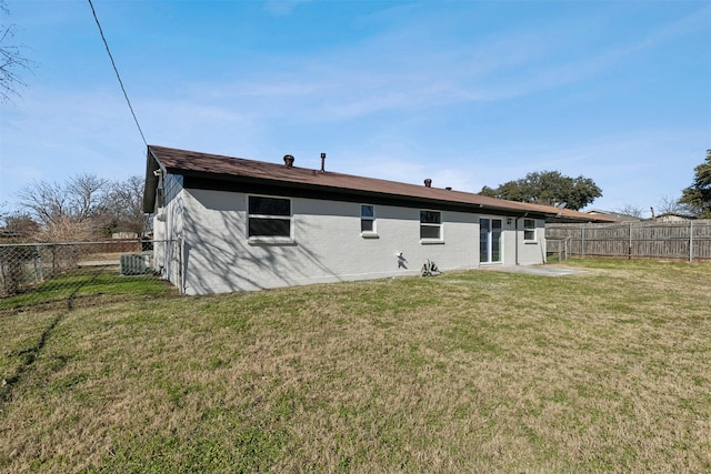 back of house with a lawn