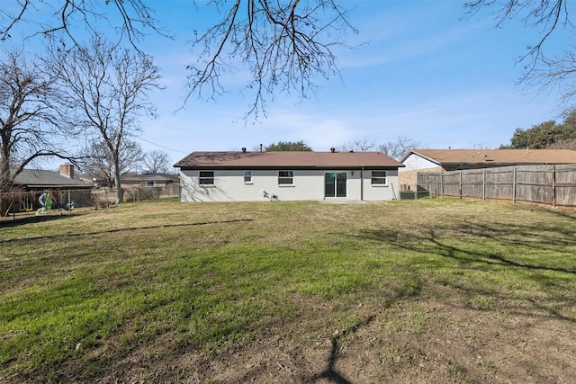 rear view of house featuring a lawn