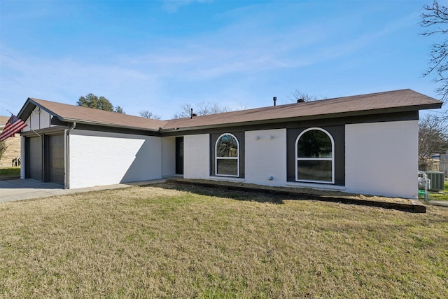 ranch-style home with a garage, a front yard, and cooling unit