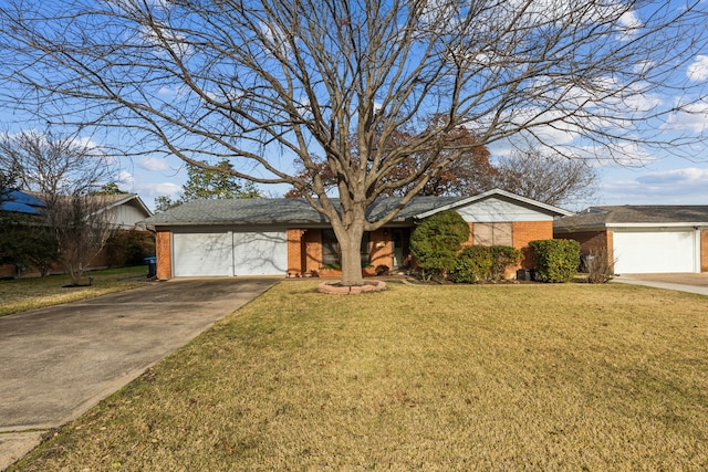 ranch-style home with a garage and a front lawn