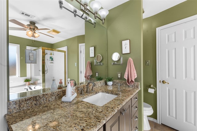 bathroom featuring walk in shower, tile patterned floors, toilet, vanity, and ceiling fan