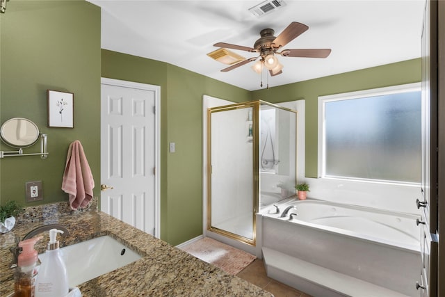 bathroom with ceiling fan, vanity, plus walk in shower, and tile patterned flooring