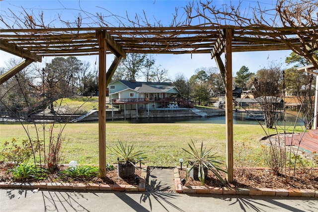 view of yard with a water view and a pergola