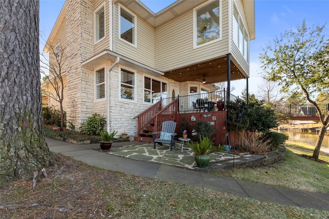 rear view of house featuring ceiling fan