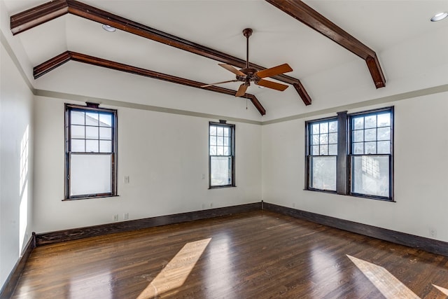 unfurnished room with dark hardwood / wood-style floors, ceiling fan, a wealth of natural light, and vaulted ceiling with beams