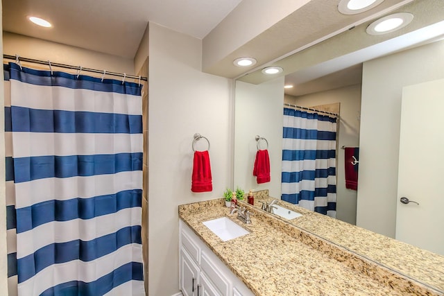 bathroom featuring vanity and curtained shower