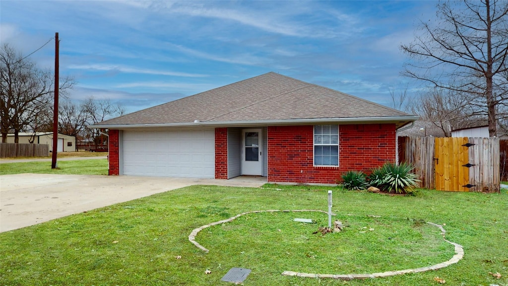 single story home featuring a garage and a front lawn