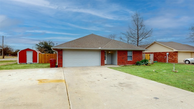 ranch-style house with a storage shed, a garage, and a front lawn