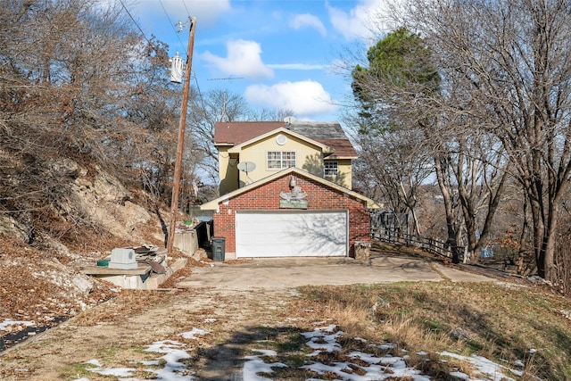 view of snow covered exterior featuring a garage