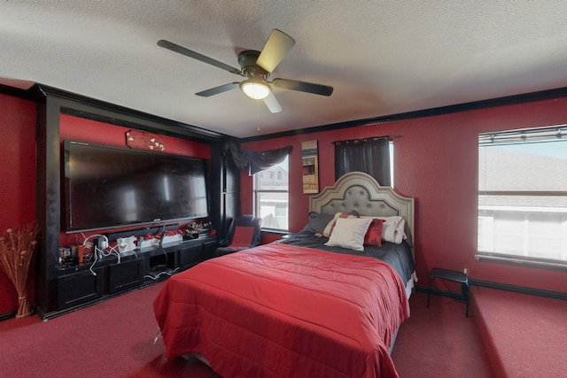 bedroom featuring ornamental molding, carpet, a textured ceiling, and ceiling fan