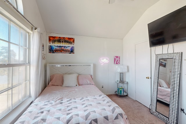 bedroom featuring light colored carpet and vaulted ceiling