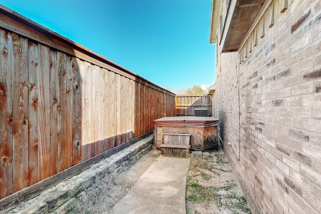 view of patio featuring central AC unit and a hot tub