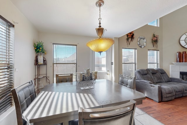 dining space featuring a tile fireplace