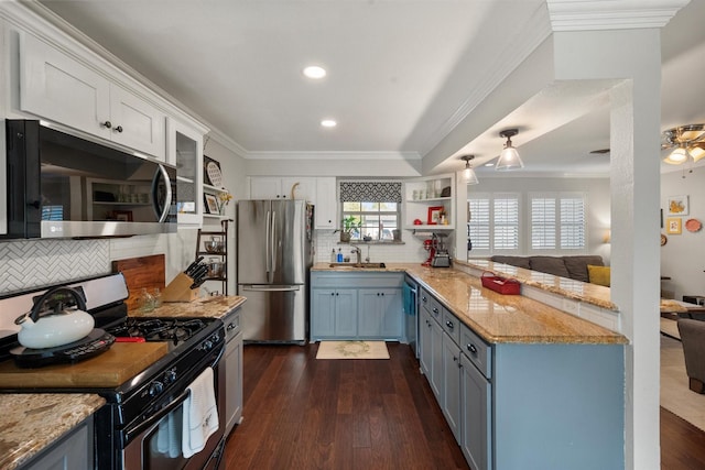 kitchen featuring sink, dark wood-type flooring, appliances with stainless steel finishes, backsplash, and white cabinets