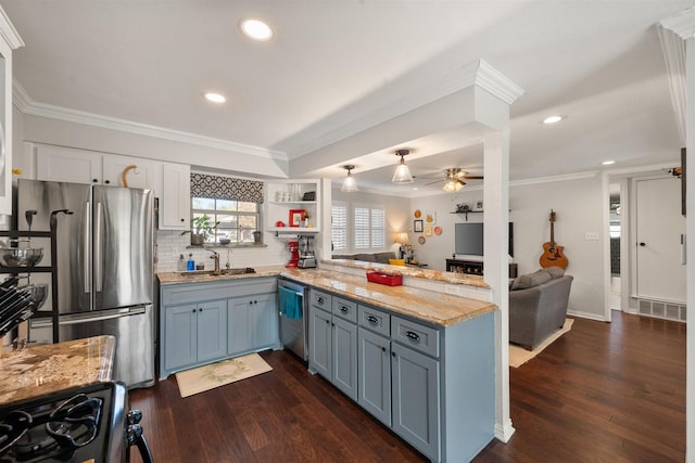 kitchen featuring white cabinetry, crown molding, kitchen peninsula, and appliances with stainless steel finishes