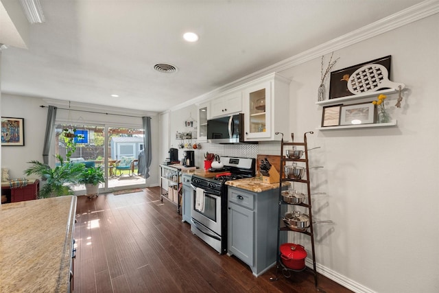 kitchen with gray cabinetry, crown molding, dark hardwood / wood-style floors, stainless steel appliances, and white cabinets