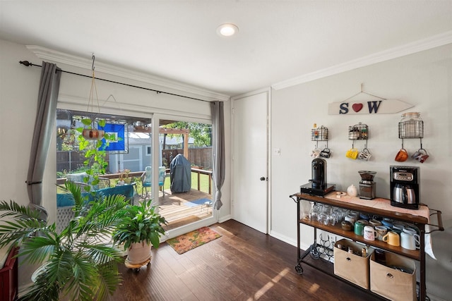 foyer with crown molding and dark wood-type flooring