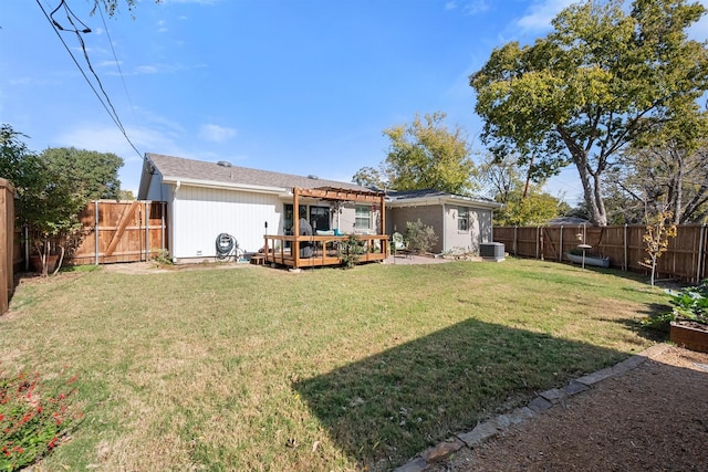 rear view of house with cooling unit, a pergola, a deck, and a lawn