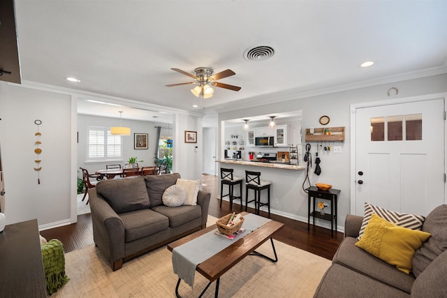 living room with crown molding, ceiling fan, and hardwood / wood-style flooring