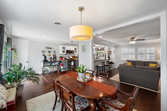 dining room featuring crown molding, dark hardwood / wood-style floors, and ceiling fan