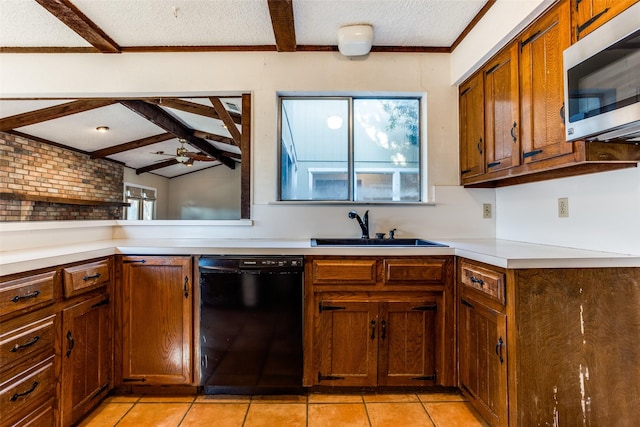 kitchen featuring dishwasher, sink, light tile patterned floors, ceiling fan, and a textured ceiling