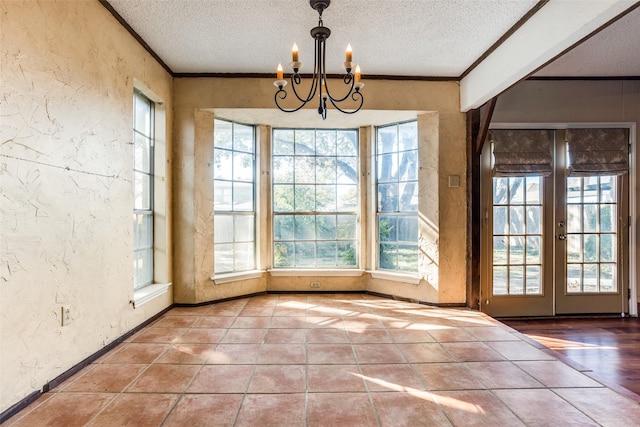 interior space featuring crown molding, tile patterned flooring, a textured ceiling, and a notable chandelier