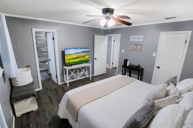 bedroom with ensuite bathroom, a textured ceiling, ornamental molding, dark hardwood / wood-style floors, and ceiling fan