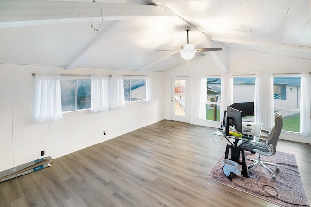 interior space with ceiling fan, wood-type flooring, lofted ceiling with beams, and a wealth of natural light