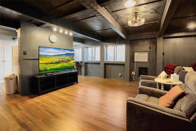 living room with hardwood / wood-style floors, a wall mounted air conditioner, beam ceiling, and wood walls