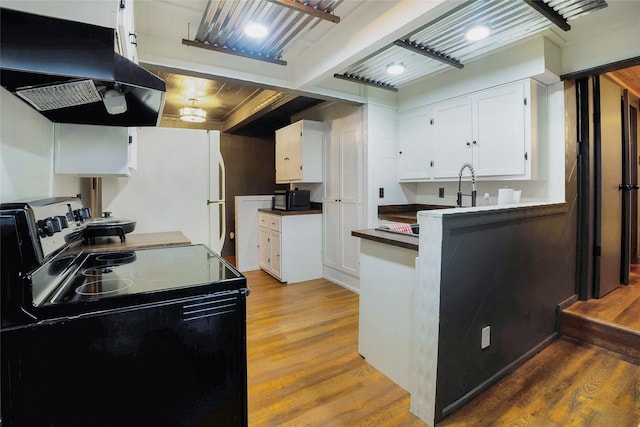 kitchen featuring island range hood, wood-type flooring, white fridge, electric stove, and white cabinets