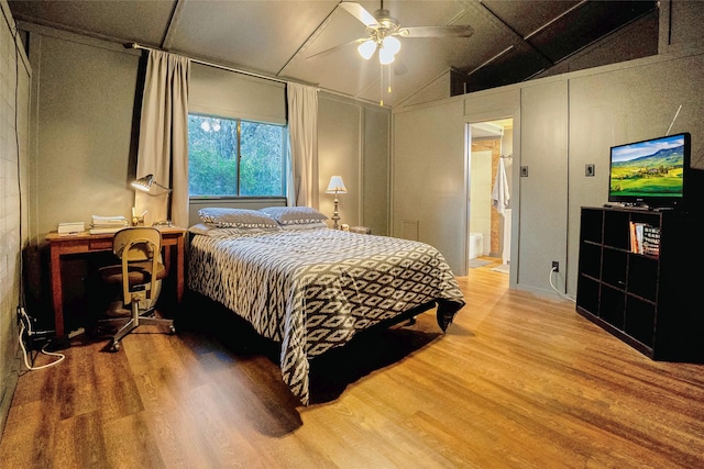 bedroom with wood-type flooring, lofted ceiling, ensuite bathroom, and ceiling fan