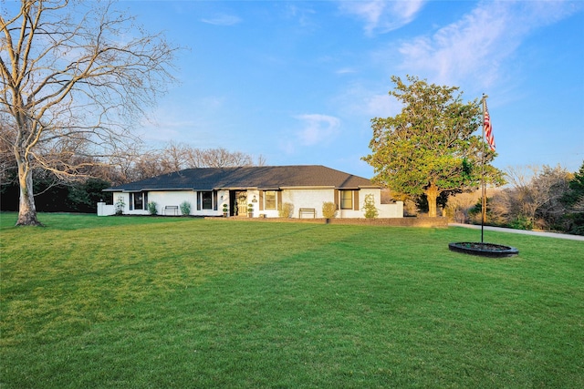 ranch-style home with a front lawn